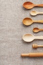 Wooden spoons made of natural wood on burlap fabric as a craft. Royalty Free Stock Photo