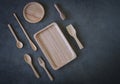 Wooden spoons and plate on dark gray gypsum on desktop Royalty Free Stock Photo