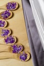 Wooden spoons with purple petals