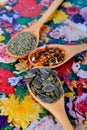 Wooden spoons with spices in on a flowery background