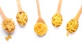 Wooden spoons with various uncooked pasta on white background Royalty Free Stock Photo