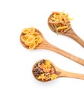 Wooden spoons with various uncooked pasta on white background Royalty Free Stock Photo