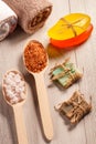 Wooden spoons with white and brown sea salt and handmade soap for bathroom procedures with towels on the background Royalty Free Stock Photo