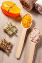 Wooden spoons with yellow and white sea salt and handmade soap f Royalty Free Stock Photo