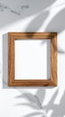 Wooden Square Frame on White Marble Background with Leaf Shadows Royalty Free Stock Photo