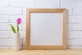 Wooden square frame mockup with pink tulip