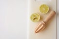 Wooden squeezer and lime cut on half on a table on a white plastic cutting board Royalty Free Stock Photo