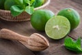 Wooden squeezer and lime on table Royalty Free Stock Photo