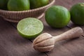 Wooden squeezer and lime on table Royalty Free Stock Photo