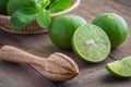 Wooden squeezer and lime on table Royalty Free Stock Photo