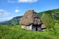 Wooden stable with thatched roof in the mountains Royalty Free Stock Photo