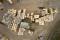 Wooden stacked pallets for freight transport at sawmill aerial view from above