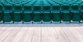 a wooden stage and rows of green chairs in the auditorium of a cinema or theater. Royalty Free Stock Photo