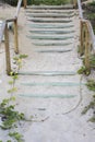 Wooden staircase covered by beach sand on tropical summer