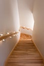 Wooden staircase decorated with lights