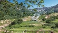 A wooden staircase descends down the hillside into the Valley of Geysers.