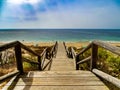 Wooden staircase that goes down to the beach and the sea Royalty Free Stock Photo