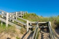 A wooden staircase going down to the beach with a beautiful blue sky and marsh grass in the sand at Pinery Provincial Park, Royalty Free Stock Photo