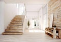 Wooden staircase and lining paneling wall in minimalist style hallway. Interior design of modern rustic entrance hall with door in Royalty Free Stock Photo