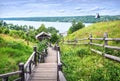 A wooden staircase from Mount Levitan with a view of the Volga River in Plyos