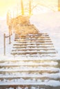 Wooden staircase with snow covered, into the light Royalty Free Stock Photo
