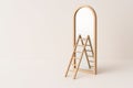 A wooden staircase stands in front of the mirror, creating the illusion of an exit. Space for text. Royalty Free Stock Photo