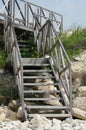 Wooden staircase on a stone beach Royalty Free Stock Photo