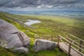 Wooden stairs and boardwalk leading down to the valley with lake from Cuilcagh Mountain peak Royalty Free Stock Photo