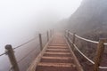 wooden stairs on a foggy day on the pedestrian path to the top of the mount vesuvio volcano.  Naples, Italy. Royalty Free Stock Photo