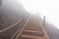 wooden stairs on a foggy day on the pedestrian path to the top of the mount vesuvio volcano.  Naples, Italy. Royalty Free Stock Photo