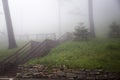 Wooden Stairs on Foggy Grass Covered Hill Royalty Free Stock Photo