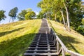 Wooden stairs going up on the hill and forest Royalty Free Stock Photo