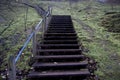 Wooden stairs going up a rural green grassy hill Royalty Free Stock Photo