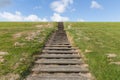 Wooden stairs upon green hill with blue sky Royalty Free Stock Photo
