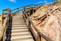 Wooden stairs with handrails leading up a rock Royalty Free Stock Photo