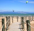 Wooden stairs and kite surfers