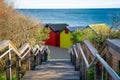 Wooden stairs leading down to iconic Brighton Beach huts. Royalty Free Stock Photo