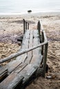 Wooden stairs leading to the beach with water in the background. Cold Baltic Sea coast. Old, empty boardwalk Royalty Free Stock Photo