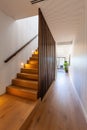 Wooden stairs leading to second floor of modern townhouse.