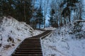 Wooden stairs leading to the snowy Hill of the Three Crosses in Vilnius at dawn. Lithuania Royalty Free Stock Photo