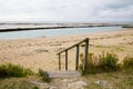 Wooden stairs pedestrian access to the sand of the beach