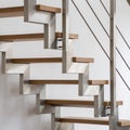 Wooden stairs with silver railing, close-up Royalty Free Stock Photo