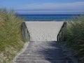 Wooden stairs to the beach between the dunes Royalty Free Stock Photo