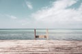 Wooden stairs to the sea, toned image. Empty wooden pier at the Indian ocean coast, filtered. Tropical vacations.