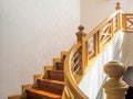 Wooden stairway with handrail and stainless banister, white wall Royalty Free Stock Photo