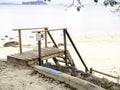 Wooden stairway to the sand beach on seascape view background. Royalty Free Stock Photo