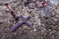 Wooden stake and cross lying on the ashes