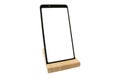 Wooden stand for smartphone isolated. Modern Mockup of a mobile phone with a white display. Environmental stands for fixing Royalty Free Stock Photo