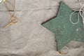 Wooden star and gray textile background