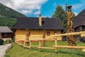 Wooden statue in front of picturesque historical village Vlkolinec witjh wooden colorful cottages in Slovakia